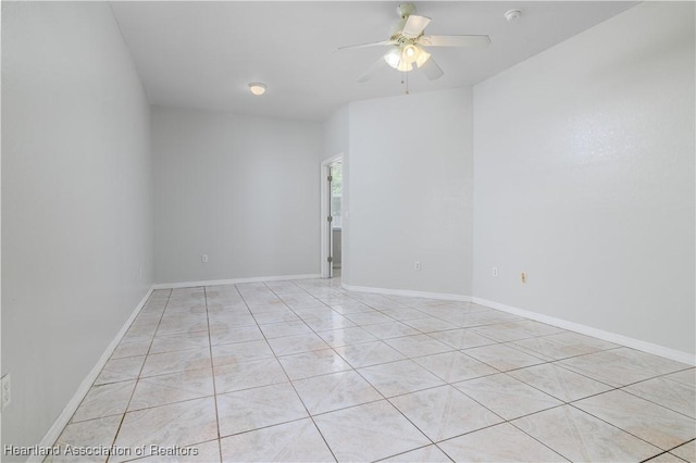 tiled empty room featuring ceiling fan