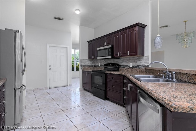 kitchen with pendant lighting, sink, dark brown cabinets, light tile patterned flooring, and stainless steel appliances