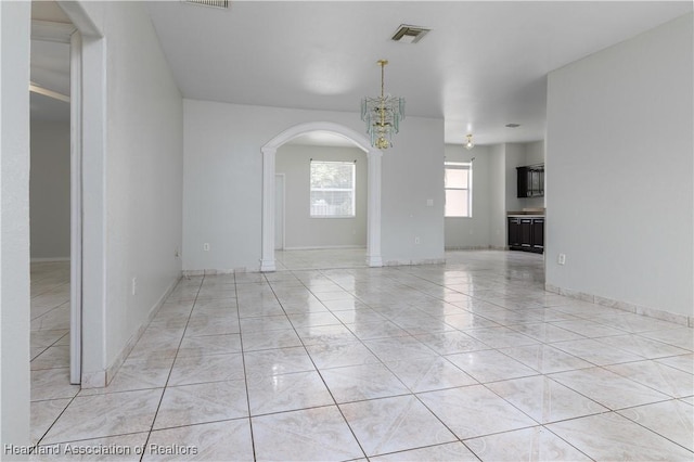 interior space featuring light tile patterned flooring and an inviting chandelier