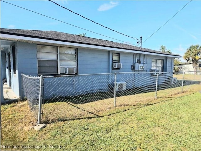 view of side of home with cooling unit and a lawn