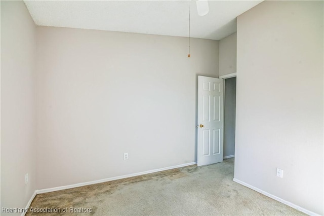 empty room with light colored carpet and ceiling fan