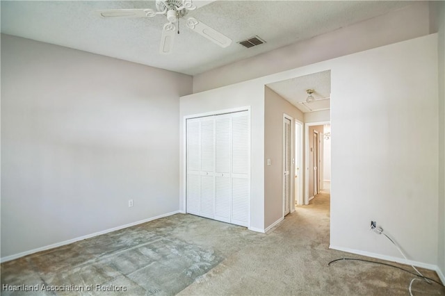 unfurnished bedroom with ceiling fan and light colored carpet