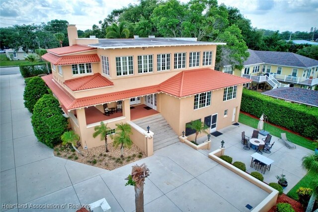 1831 Lakeview Dr, Sebring, FL 33870 - mediterranean / spanish-style house featuring stucco siding, a patio area, and a tile roof