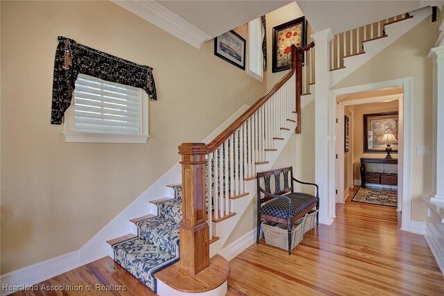 1831 Lakeview Dr, Sebring, FL 33870 - staircase with wood finished floors, baseboards, and crown molding