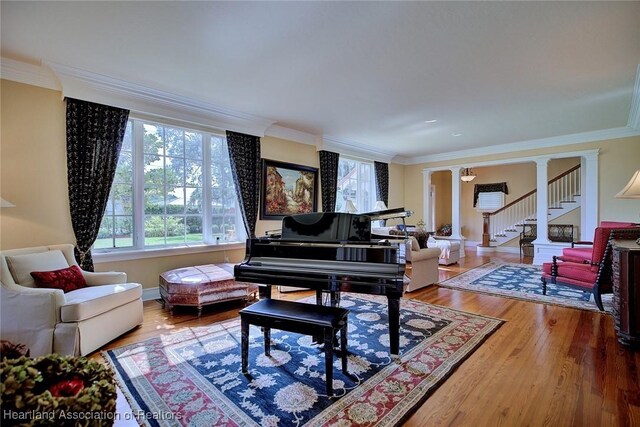 1831 Lakeview Dr, Sebring, FL 33870 - sitting room featuring crown molding, wood finished floors, stairs, and baseboards