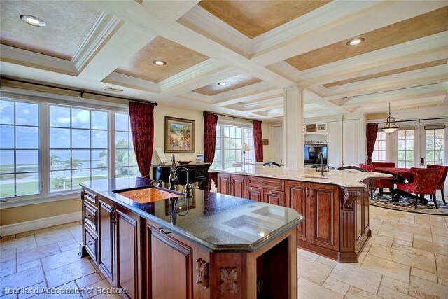 1831 Lakeview Dr, Sebring, FL 33870 - kitchen featuring a kitchen island with sink, a sink, stone tile flooring, plenty of natural light, and coffered ceiling