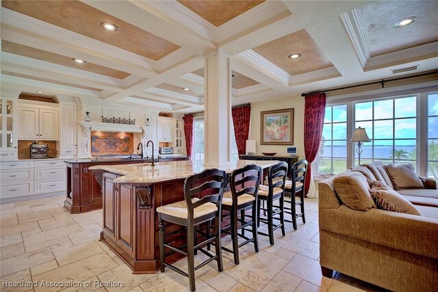 1831 Lakeview Dr, Sebring, FL 33870 - kitchen with stone tile floors, a large island with sink, healthy amount of natural light, coffered ceiling, and beam ceiling