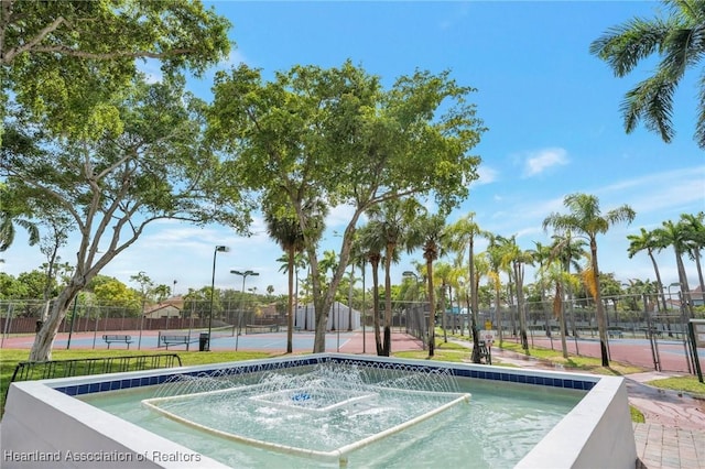 18210 Mediterranean Blvd Unit 5-20, Hialeah, FL 33015 - view of swimming pool with a tennis court and fence