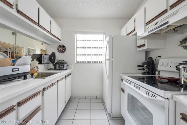 18210 Mediterranean Blvd Unit 5-20, Hialeah, FL 33015 - kitchen featuring white electric range oven, under cabinet range hood, light countertops, white cabinets, and black microwave
