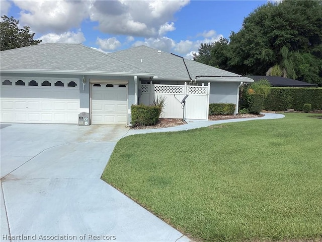 view of front of home with a front lawn and a garage