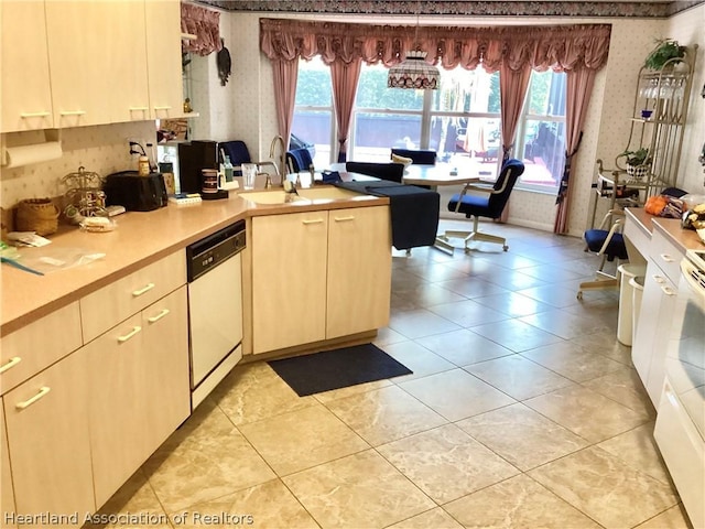 kitchen featuring white dishwasher, plenty of natural light, light tile patterned flooring, and sink