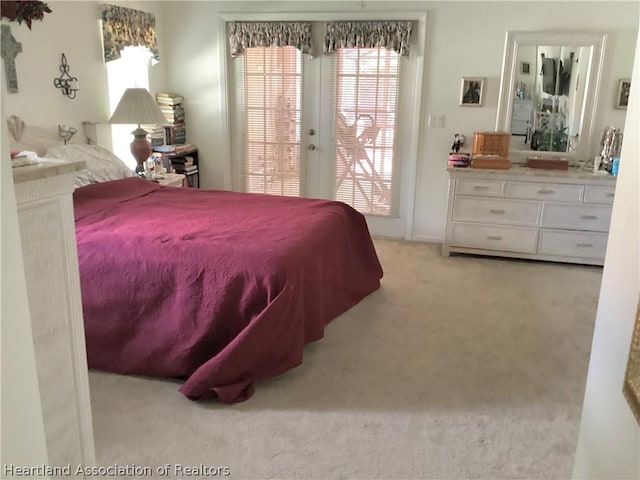 bedroom featuring light colored carpet