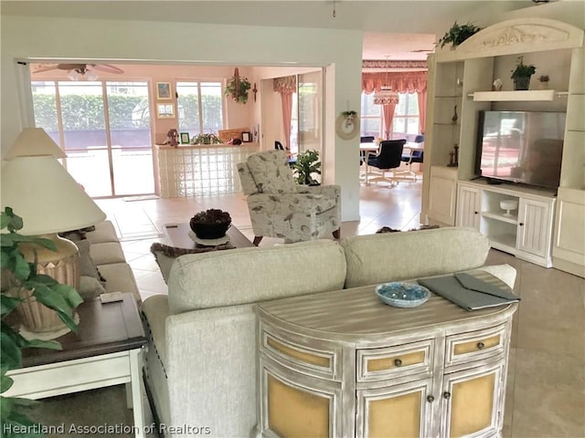 living room featuring tile patterned flooring and ceiling fan