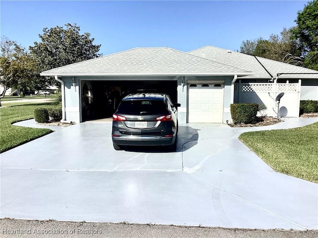 2831 Sunrise Dr, Sebring, FL 33872 - view of front of home with a garage, a shingled roof, and concrete driveway