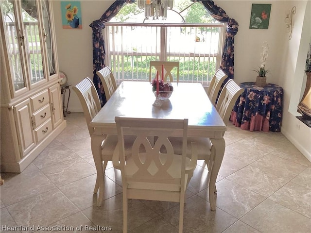 dining area featuring a notable chandelier and light tile patterned floors