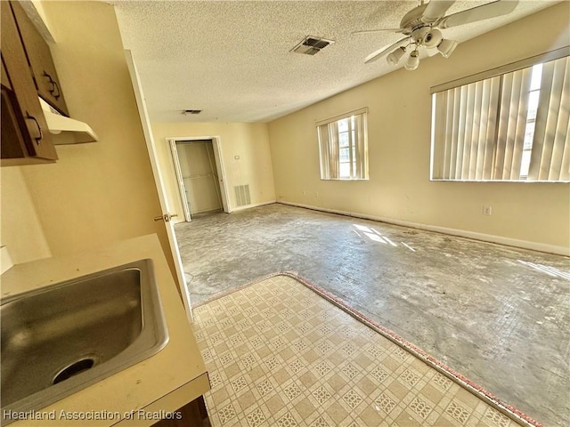 2525 Country Rd, Sebring, FL 33872 - interior space with visible vents, a ceiling fan, baseboards, and a sink