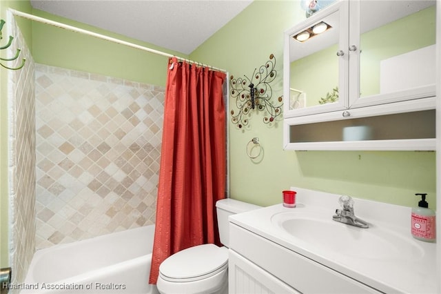 bathroom featuring vanity, shower / bath combo, and toilet