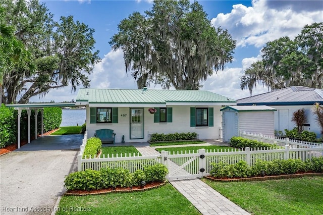 457 Lake June Rd, Lake Placid, FL 33852 - ranch-style home featuring driveway, a gate, metal roof, and a carport