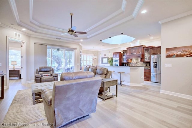 3013 Royal Oaks Ct, Sebring, FL 33875 - living area with a raised ceiling, ceiling fan, crown molding, light wood-type flooring, and recessed lighting