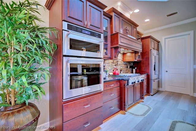 3013 Royal Oaks Ct, Sebring, FL 33875 - kitchen with appliances with stainless steel finishes, ornamental molding, tasteful backsplash, light wood-type flooring, and recessed lighting