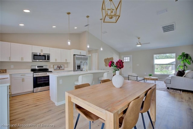 4001 Simca St, Sebring, FL 33872 - dining area featuring light wood-style floors, high vaulted ceiling, recessed lighting, and ceiling fan
