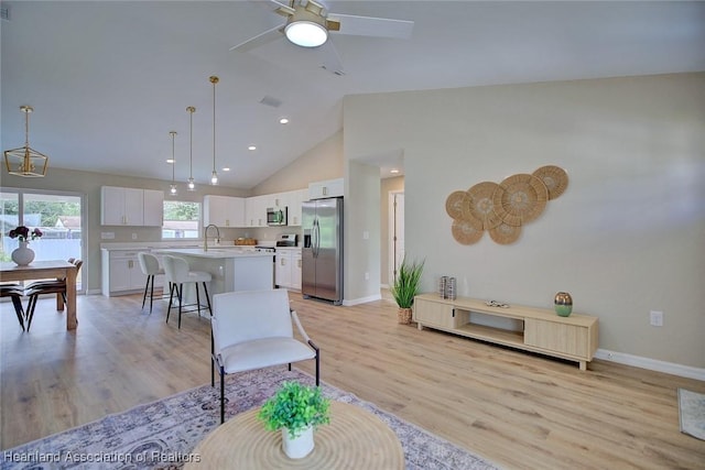 4001 Simca St, Sebring, FL 33872 - living area featuring light wood-style floors, baseboards, a ceiling fan, high vaulted ceiling, and recessed lighting