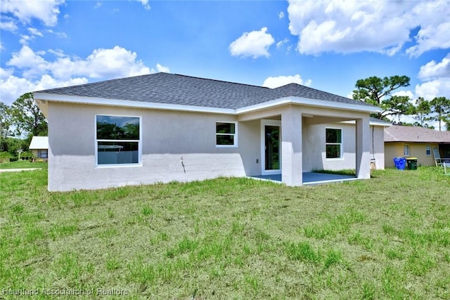 4001 Simca St, Sebring, FL 33872 - back of house with stucco siding, a yard, a patio area, and roof with shingles