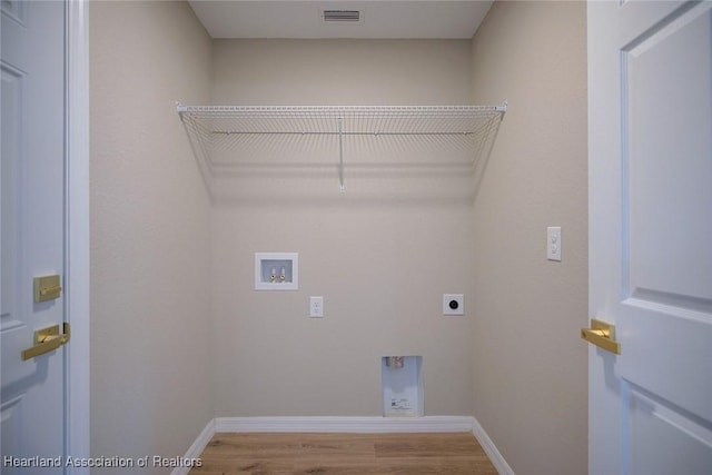 4001 Simca St, Sebring, FL 33872 - laundry area with hookup for an electric dryer, hookup for a washing machine, wood finished floors, and baseboards