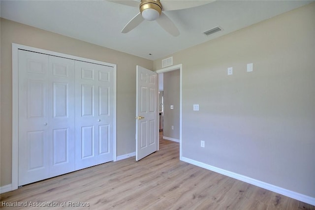 4001 Simca St, Sebring, FL 33872 - unfurnished bedroom with light wood-style flooring, baseboards, a closet, and ceiling fan