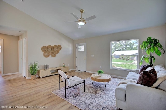 4001 Simca St, Sebring, FL 33872 - living area featuring a ceiling fan, light wood-type flooring, baseboards, and high vaulted ceiling
