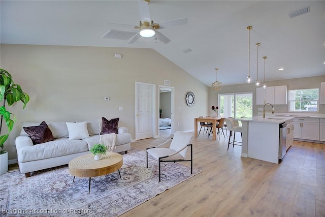 4001 Simca St, Sebring, FL 33872 - living room featuring light wood-type flooring, ceiling fan, baseboards, and high vaulted ceiling
