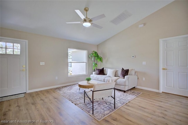 4001 Simca St, Sebring, FL 33872 - living area with light wood-style flooring, a ceiling fan, baseboards, and high vaulted ceiling