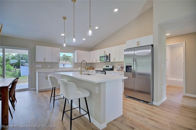 4001 Simca St, Sebring, FL 33872 - kitchen featuring appliances with stainless steel finishes, a sink, light wood-style flooring, light countertops, and white cabinetry
