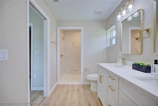 4001 Simca St, Sebring, FL 33872 - full bath with wood finished floors, a marble finish shower, toilet, double vanity, and baseboards