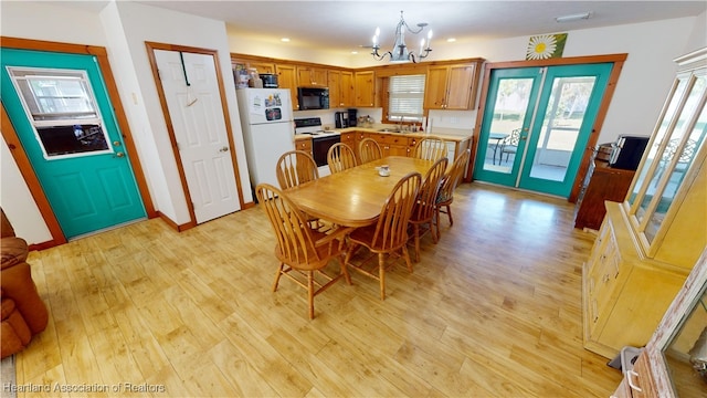 dining area with a chandelier and light wood-type flooring