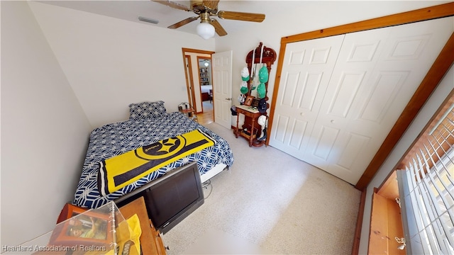 bedroom featuring ceiling fan and a closet