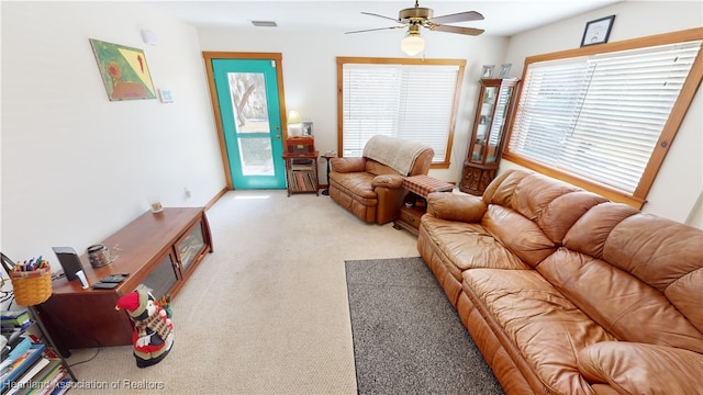 living room with ceiling fan and light colored carpet