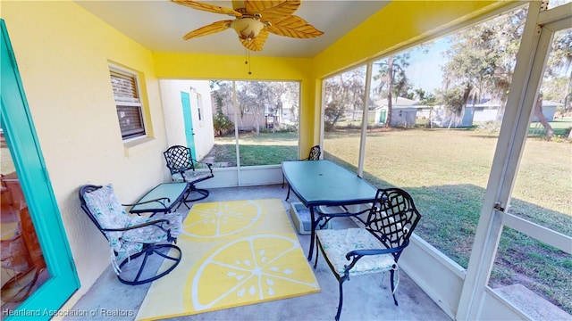 sunroom / solarium with ceiling fan and a healthy amount of sunlight