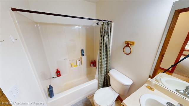 full bathroom with shower / tub combo with curtain, vanity, and toilet