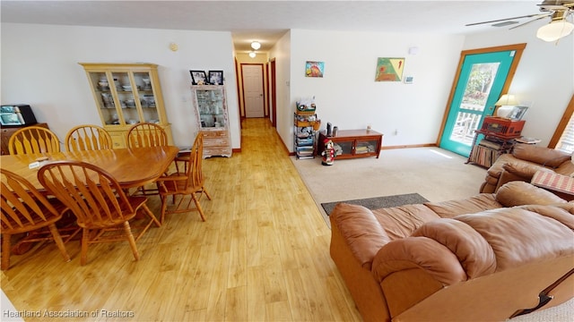 living room featuring ceiling fan and light hardwood / wood-style flooring