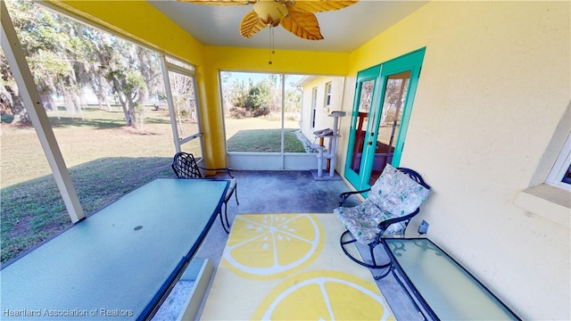 sunroom featuring ceiling fan