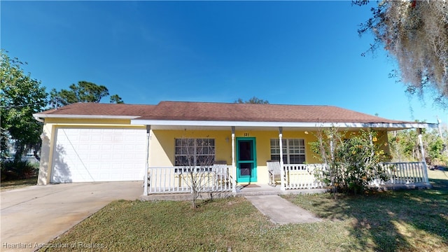 single story home featuring covered porch, a front yard, and a garage