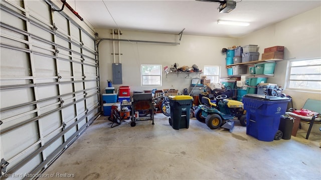 garage with electric panel and a garage door opener