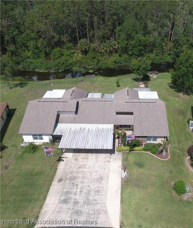 birds eye view of property with a forest view