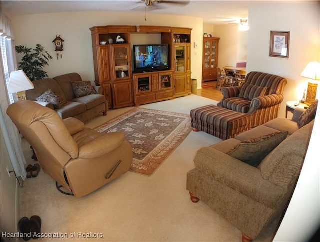 living area with carpet flooring and a ceiling fan