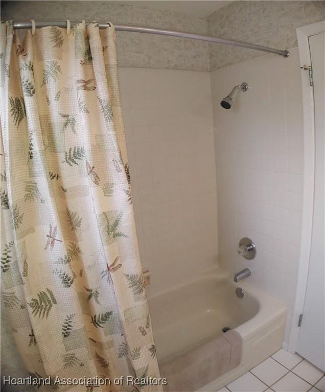 full bath featuring tile patterned flooring and shower / tub combo