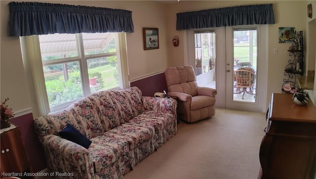 carpeted living area with french doors