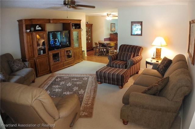 carpeted living room featuring ceiling fan