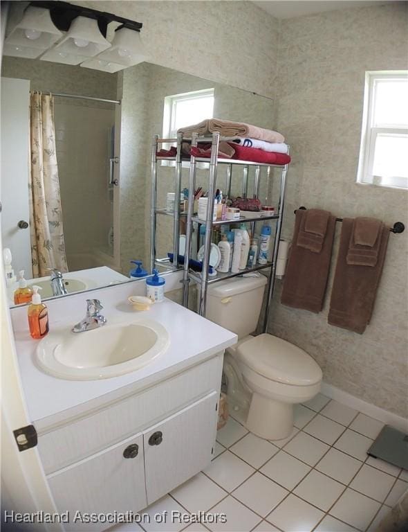 bathroom featuring tile patterned floors, toilet, a shower with shower curtain, wallpapered walls, and vanity