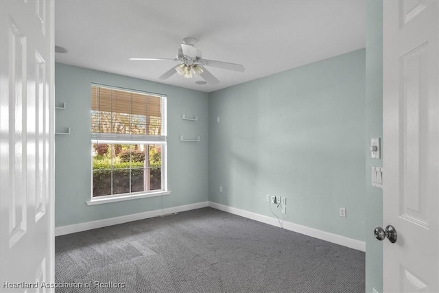 carpeted empty room featuring ceiling fan